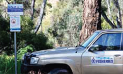 fisheries 4wd parked at a fishing sign
