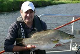 Fisherman Holding a Barramundi