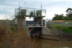 Within enclosed compound on top of outlet structure