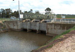 Within enclosed compound on top of outlet structure