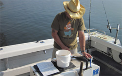 An angler diarist measuring his catch.